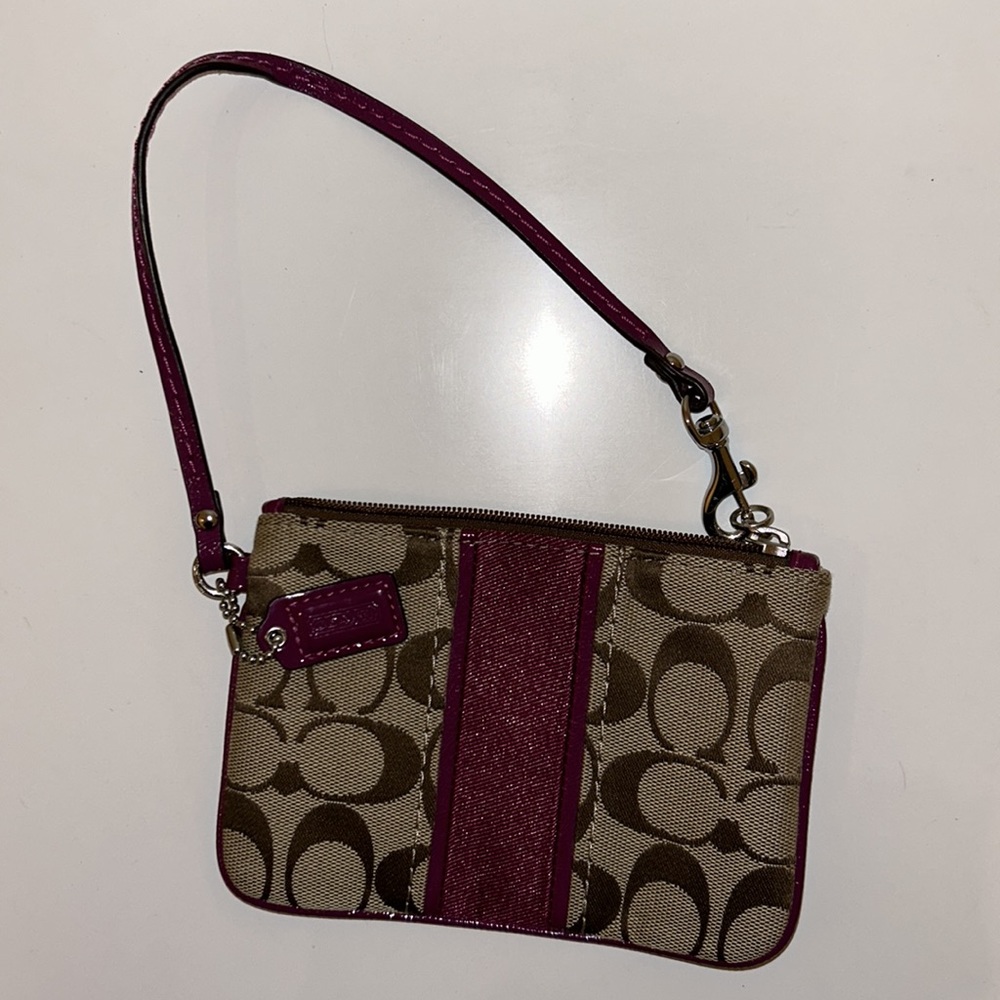 Coach wristlet with maroon detailing. 6.5 in x 4.5 in
